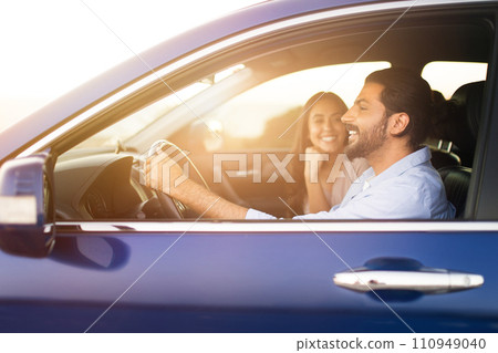 Joyful middle eastern couple in car ready for a road trip Joyful middle eastern couple in car ready for a road trip 110949040