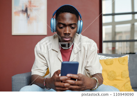 Guy watching movie in smartphone Guy watching movie in smartphone 110949090