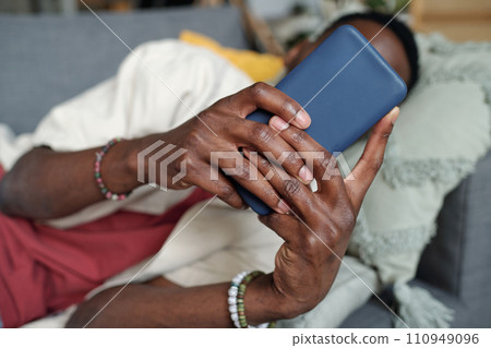 Hands of young man with smartphone Hands of young man with smartphone 110949096