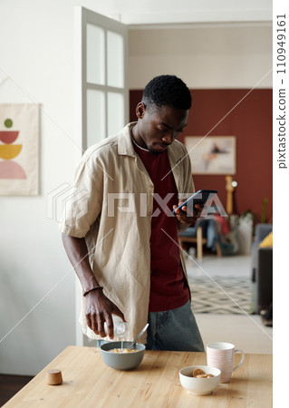 Pouting milk and texting in smartphone 110949161