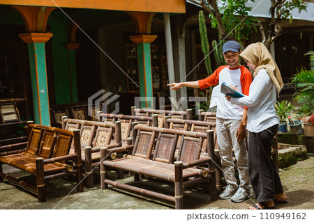 Asian man and woman in hijab handicraft businessman checking goods 110949162