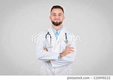 Smiling male doctor with arms crossed in lab coat Smiling male doctor with arms crossed in lab coat 110949222