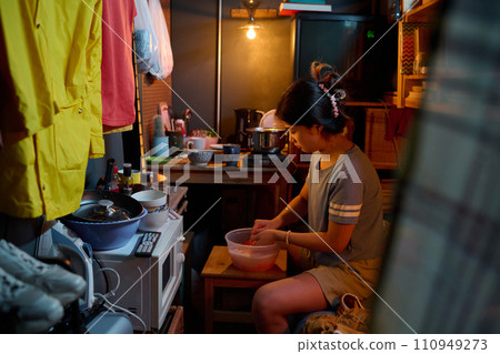 Sitting on bed and washing clothes 110949273