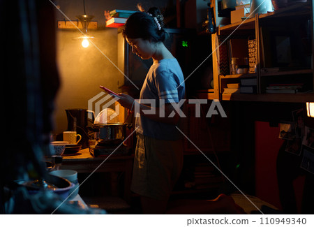 Girl with smartphone cooking food Girl with smartphone cooking food 110949340