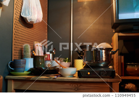 Metallic pan standing on electric stove Metallic pan standing on electric stove 110949455