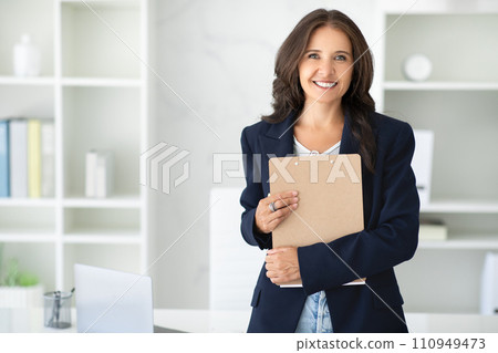 Successful middle aged corporate businesswoman posing in her office Successful middle aged corporate businesswoman posing in her office 110949473