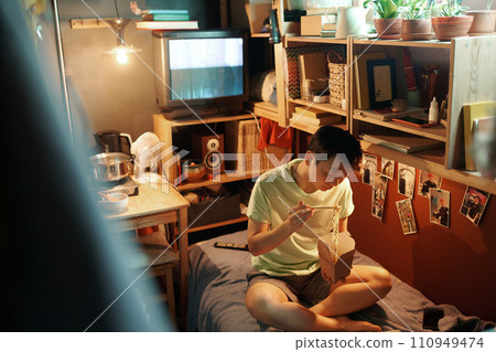 Young Asian woman eating Chinese wok 110949474