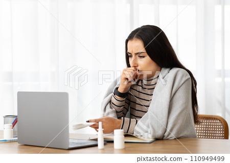 Unhappy millennial arab woman in plaid sick, coughs, suffer from cold, flu, health problems, feeling bad 110949499
