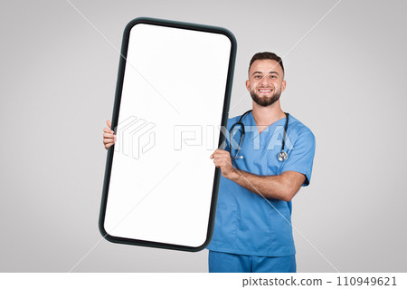 Doctor man holding large phone with blank screen for medical ad, mockup 110949621