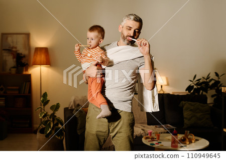 Brushing teeth together in living room 110949645