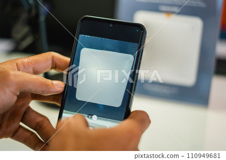 a person's hand using a mobile phone to scan a virtual barcode a person's hand using a mobile phone to scan a virtual barcode 110949681