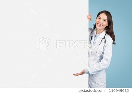 Joyful female doctor points at ad board Joyful female doctor points at ad board 110949683