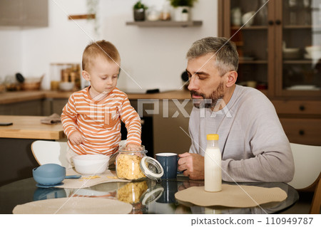 Cute baby boy taking cornflakes from jar 110949787