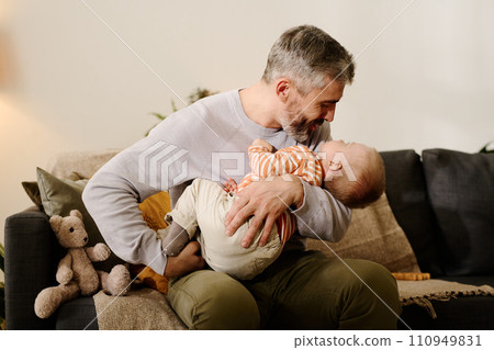 Mature father lulling adorable son Mature father lulling adorable son 110949831
