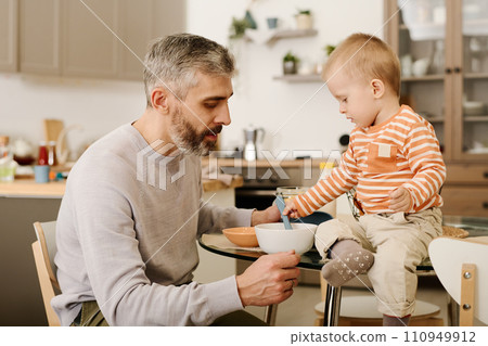Father and son having breakfast together Father and son having breakfast together 110949912