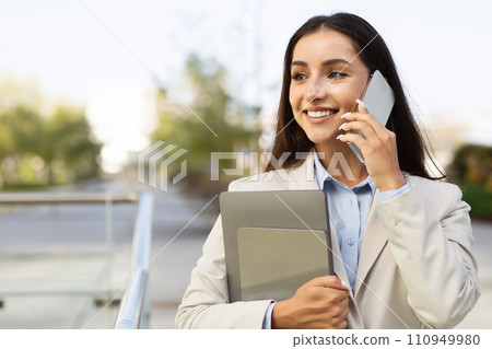 Cheerful pretty confident young woman in suit with tablet enjoy work, call by smartphone 110949980