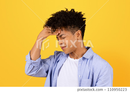 Worried young black man with hand on forehead Worried young black man with hand on forehead 110950223