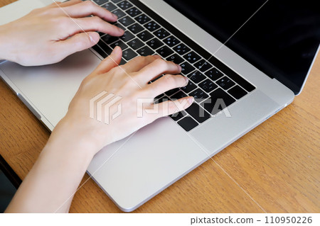 Hands working on a computer Hands working on a computer 110950226