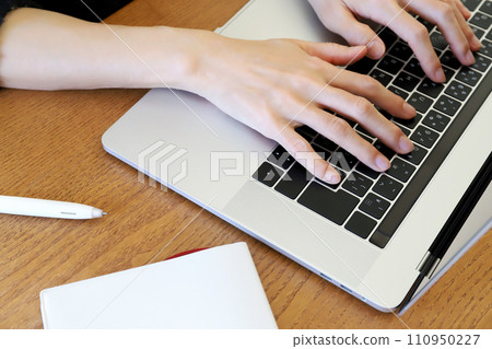Hands working on a computer Hands working on a computer 110950227