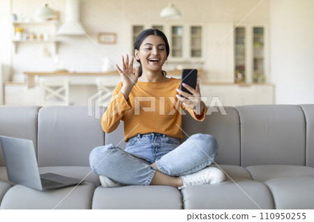 Video Call. Happy Indian Woman Teleconferencing Via Smartphone At Home Video Call. Happy Indian Woman Teleconferencing Via Smartphone At Home 110950255
