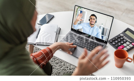Middle Eastern Woman Video Calling Via Laptop Indoor Middle Eastern Woman Video Calling Via Laptop Indoor 110950393