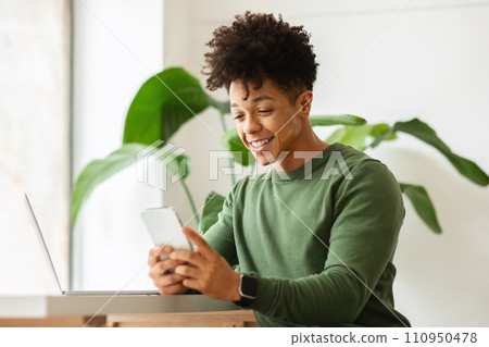 Black guy independent contractor working at cafe, using gadgets 110950478