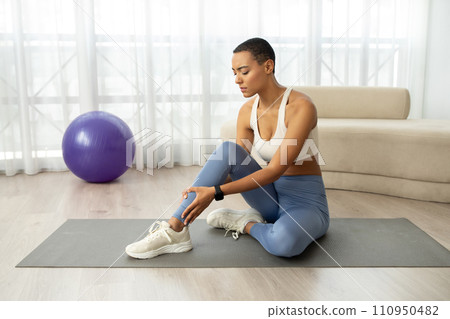 Sad millennial slim latin lady in sportswear has problems with legs, muscle strain, injury and spasm Sad millennial slim latin lady in sportswear has problems with legs, muscle strain, injury and spasm 110950482