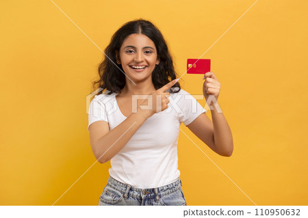 Positive young indian lady showing bank credit card 110950632