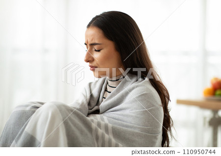 Sad young arab woman in plaid sick, suffer from cold, health problems, pain and headache Sad young arab woman in plaid sick, suffer from cold, health problems, pain and headache 110950744