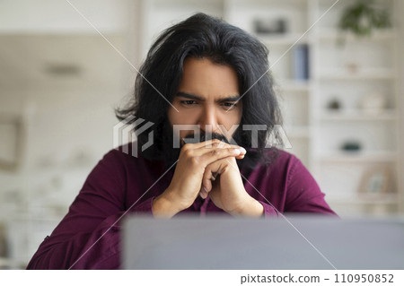 Brainstorming Concept. Thoughtful Indian Man At Workplace Looking At Laptop Screen 110950852