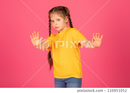 Scared Little Girl Showing Stop Gesture With Hands And Looking At Camera 110951052