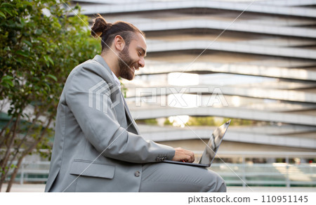 Outdoor Office. Happy Young Businessman Working With Laptop Outside Against Urban Building Outdoor Office. Happy Young Businessman Working With Laptop Outside Against Urban Building 110951145