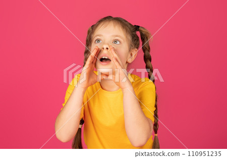 Cute little girl keeping hands near mouth and shouting at copy space 110951235
