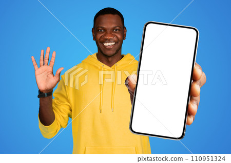 African man holding large black cellphone with blank screen, studio African man holding large black cellphone with blank screen, studio 110951324