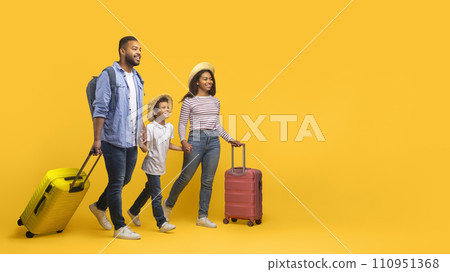 Happy cheerful african american family of three walking with suitcases Happy cheerful african american family of three walking with suitcases 110951368