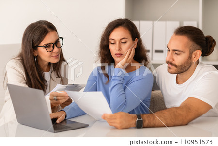 Joyful newlyweds pensive young european couple engage in property discussion Joyful newlyweds pensive young european couple engage in property discussion 110951573