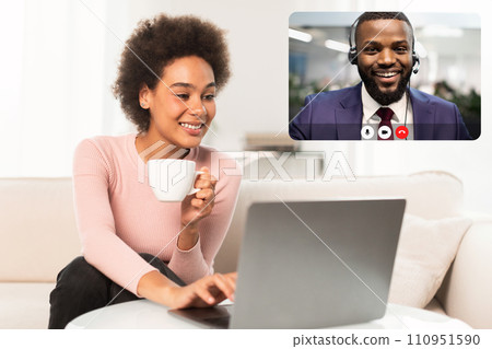 Positive african american lady have video call with colleague Positive african american lady have video call with colleague 110951590