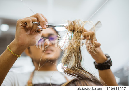cropped view of asian barber cutting customer hair cropped view of asian barber cutting customer hair 110951627