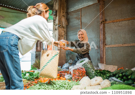 happy seller selling vegetable in greengrocery stall 110951898