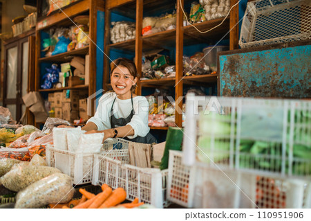 happy vegetable seller arranging products in farmer market 110951906
