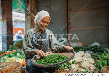 asian female seller checking vegetable product 110951965