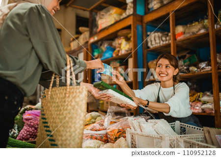 happy green grocery seller doing transaction with customer happy green grocery seller doing transaction with customer 110952128
