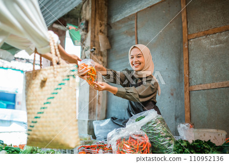 asian greengrocery seller excited selling vegetables 110952136