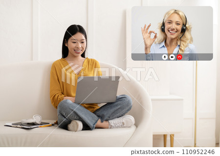 Positive young chinese woman calling tech support Positive young chinese woman calling tech support 110952246