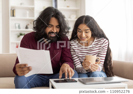 Indian Married Couple Planning Budget Together At Home 110952276