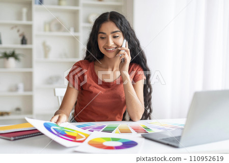 Positive creative millennial indian woman freelancer working from home 110952619
