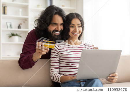 Happy young indian family shopping or banking online from home 110952678
