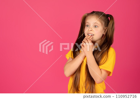 Pensive young girl looking at copy space with excitement and biting nails Pensive young girl looking at copy space with excitement and biting nails 110952716