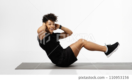 Fit Guy Flexing Abs Muscles Doing Sit Ups Exercise, Studio Fit Guy Flexing Abs Muscles Doing Sit Ups Exercise, Studio 110953156