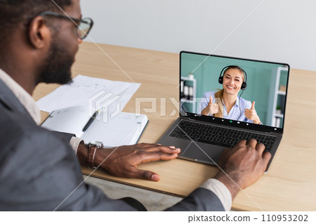Millennial black entrepreneur working on laptop pc have video call 110953202